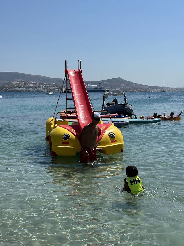 Private watersports group enjoying SUPs and pedal boats at Krios Beach, Paros